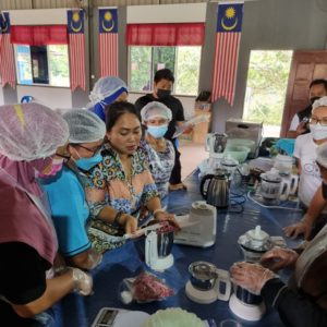 Trainer Ms. Mary Jim (MJ) explains and demonstrates how to process the herbs, ensuring the
product quality and packaging procedures